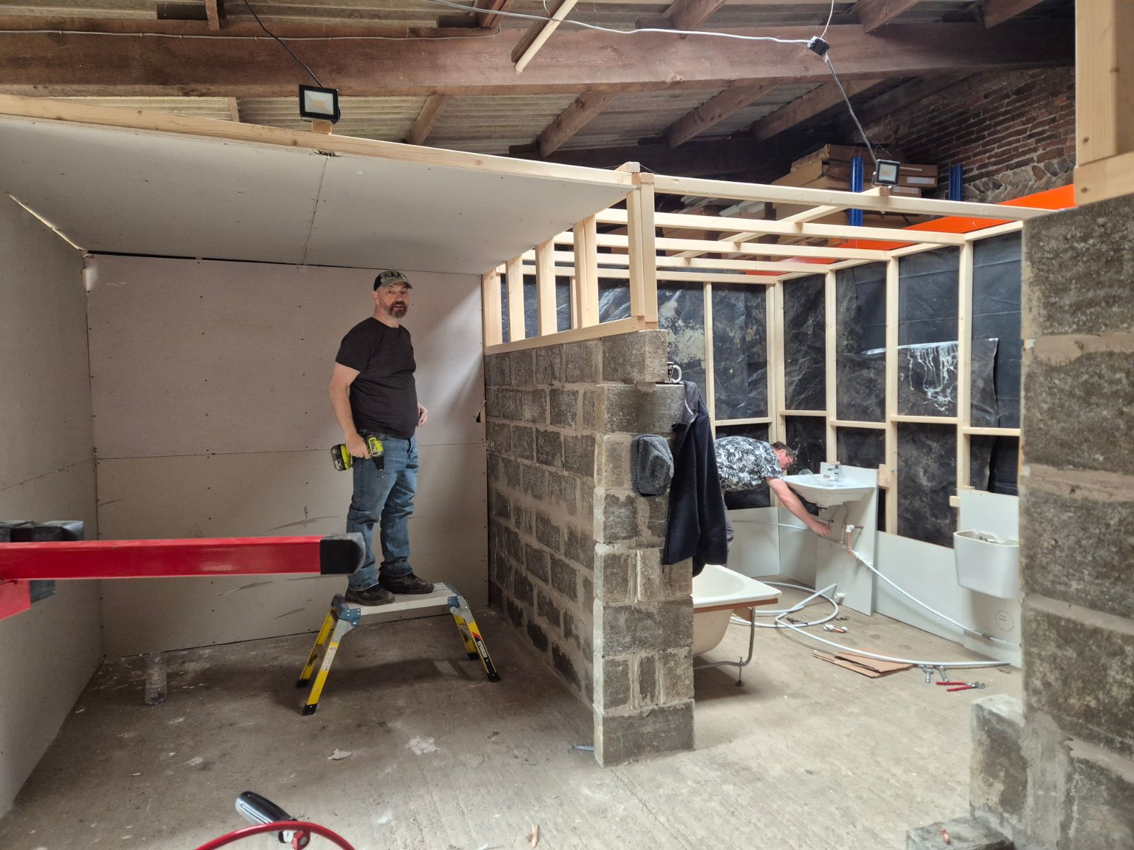 Plastering course participant finishing a training wall in the workshop