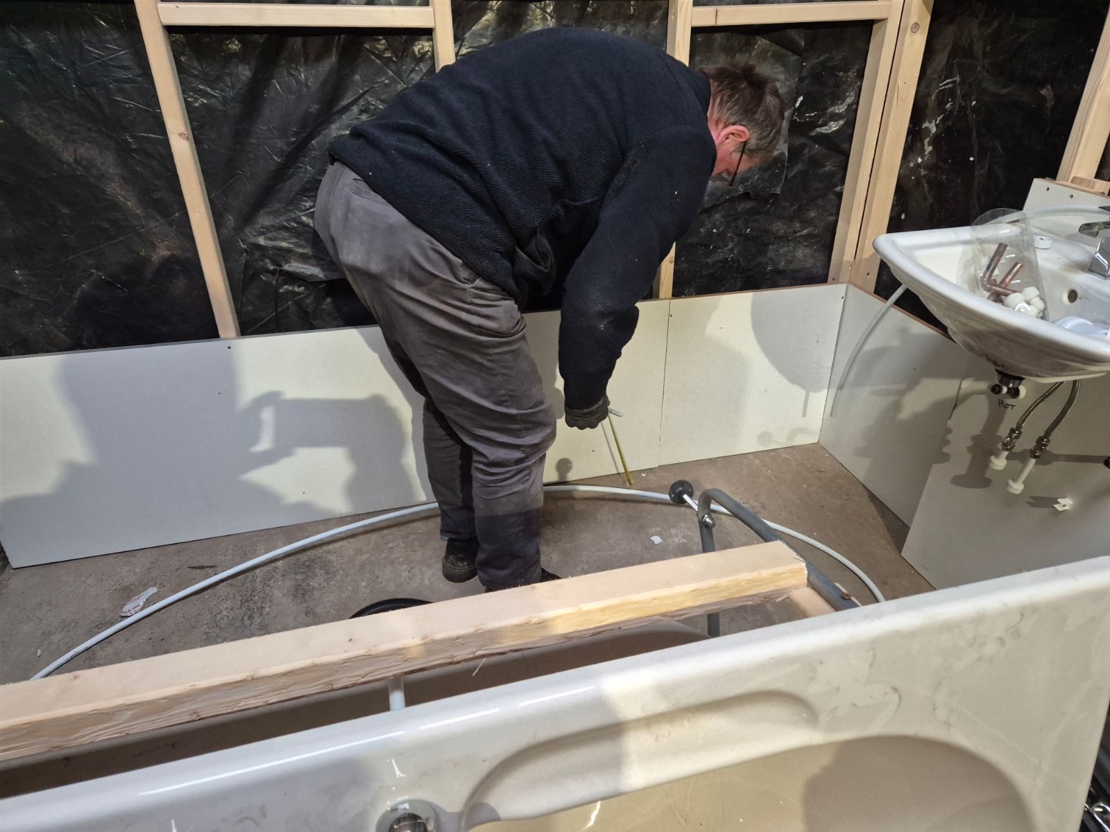Hands-on bathroom fitting practice inside the training workshop
